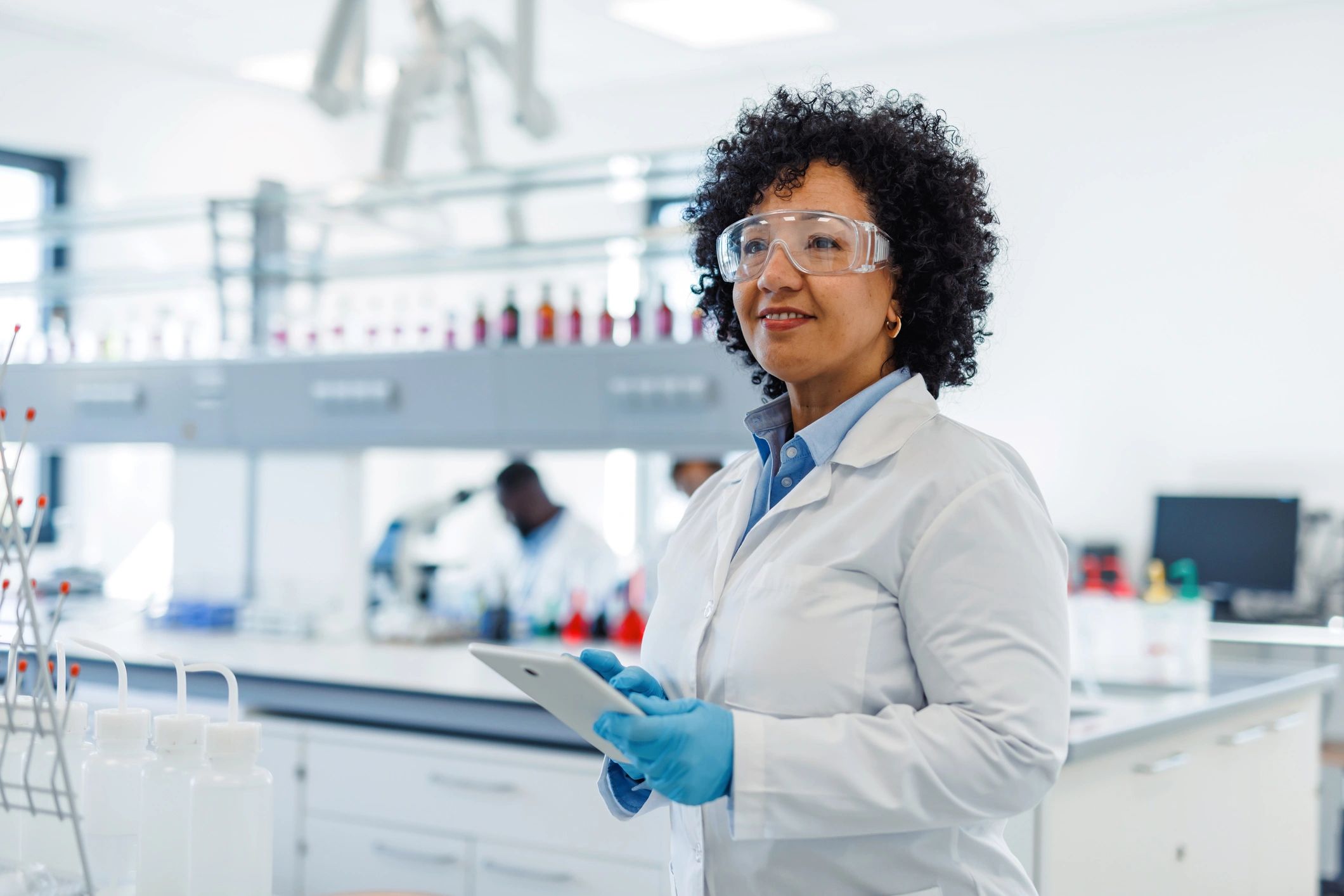 Scientist using a tablet to support laboratory testing